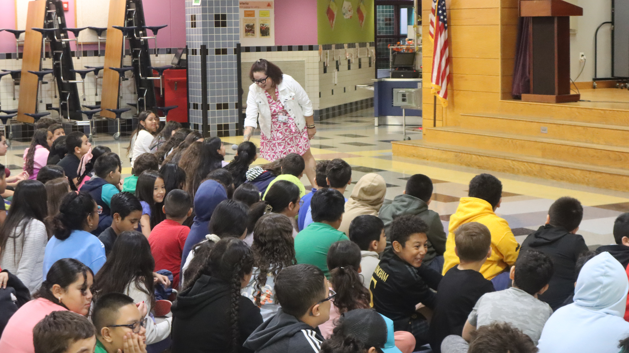 CPS teacher Vanessa Rosalan asks a student a question at the assembly